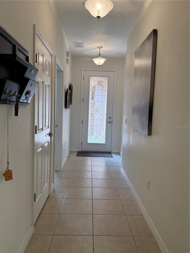 2495 Palm Tree Dr, Kissimmee, FL 34759 - foyer entrance with light tile patterned floors and baseboards