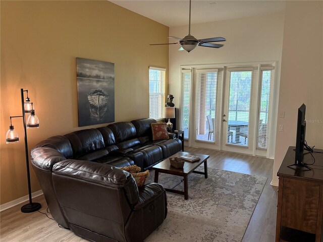 2495 Palm Tree Dr, Kissimmee, FL 34759 - living area with wood finished floors, a ceiling fan, baseboards, and a high ceiling