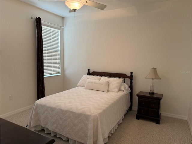 2495 Palm Tree Dr, Kissimmee, FL 34759 - bedroom featuring light carpet, baseboards, and ceiling fan