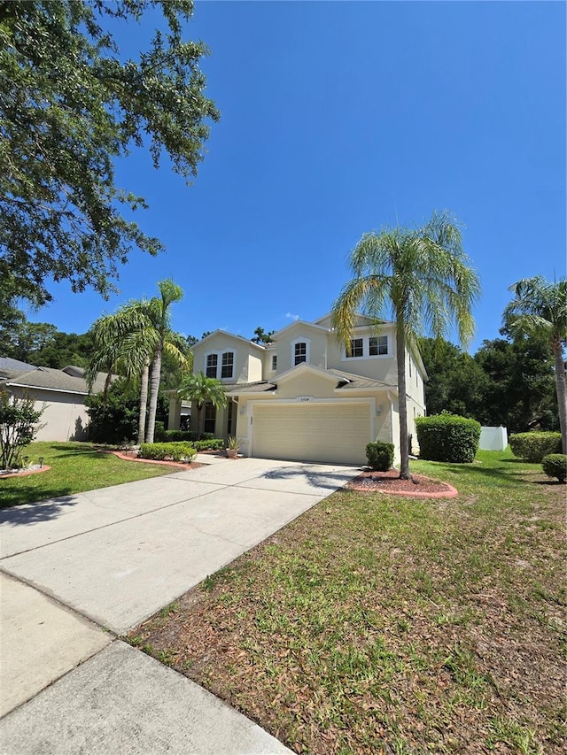 5704 Ansley Way, Mount Dora, FL 32757 - traditional-style home with driveway, a front lawn, an attached garage, and stucco siding