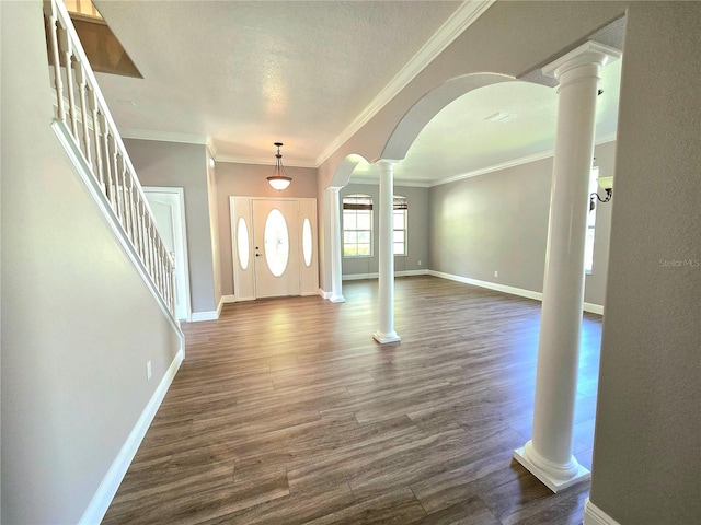 5704 Ansley Way, Mount Dora, FL 32757 - entrance foyer featuring arched walkways, ornate columns, dark wood-style floors, baseboards, and ornamental molding