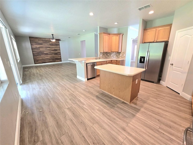 5704 Ansley Way, Mount Dora, FL 32757 - kitchen with appliances with stainless steel finishes, baseboards, light countertops, a peninsula, and recessed lighting
