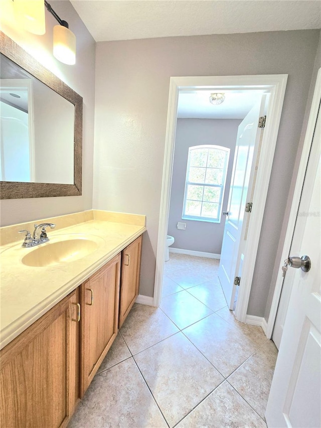 5704 Ansley Way, Mount Dora, FL 32757 - bathroom with vanity, toilet, baseboards, and tile patterned flooring