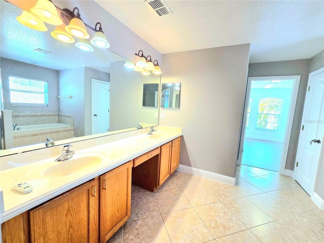 5704 Ansley Way, Mount Dora, FL 32757 - full bathroom with double vanity, a garden tub, baseboards, tile patterned floors, and a textured ceiling
