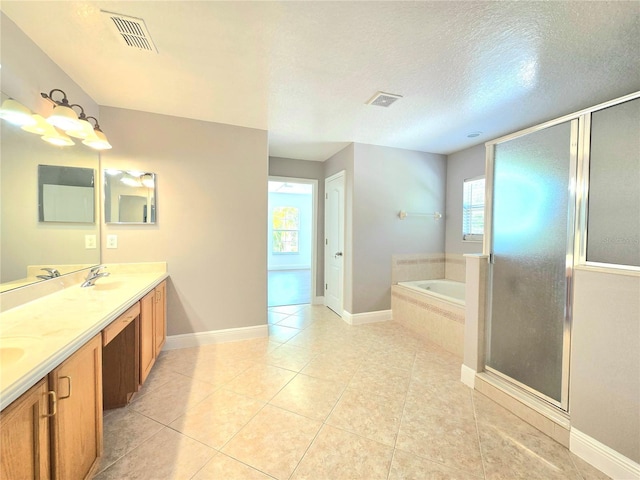 5704 Ansley Way, Mount Dora, FL 32757 - full bath with a garden tub, double vanity, healthy amount of natural light, a shower stall, and a textured ceiling
