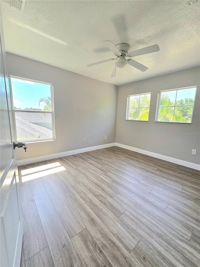 5704 Ansley Way, Mount Dora, FL 32757 - spare room featuring wood finished floors, baseboards, a textured ceiling, and a ceiling fan