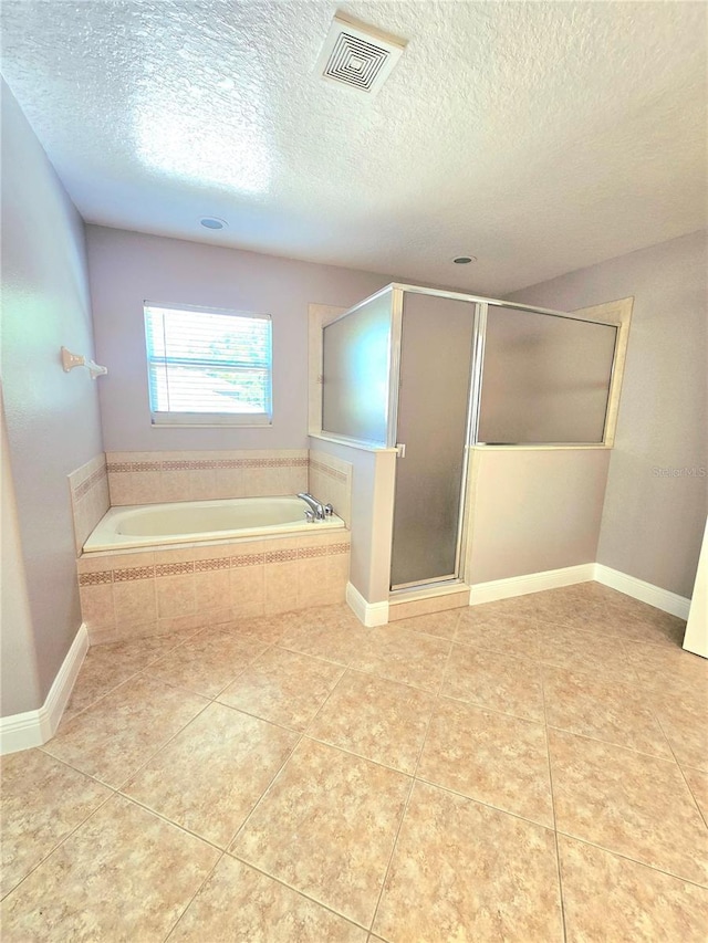 5704 Ansley Way, Mount Dora, FL 32757 - full bathroom with a bath, a stall shower, tile patterned floors, and a textured ceiling
