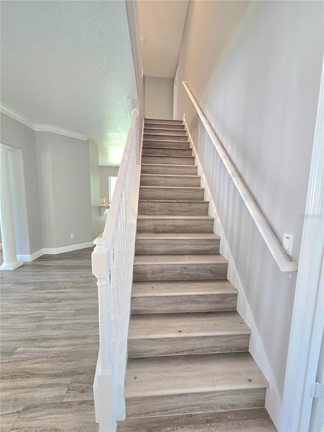 5704 Ansley Way, Mount Dora, FL 32757 - stairs featuring wood finished floors, ornamental molding, and baseboards