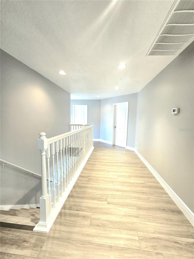 5704 Ansley Way, Mount Dora, FL 32757 - hall featuring baseboards, light wood-style flooring, recessed lighting, and an upstairs landing