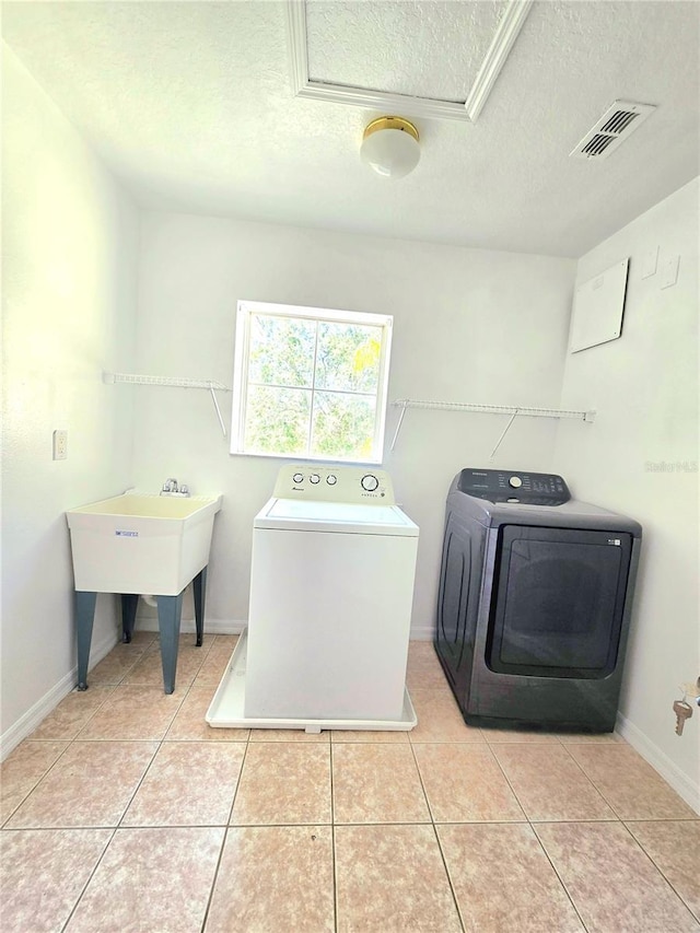 5704 Ansley Way, Mount Dora, FL 32757 - laundry room with washer and clothes dryer, a textured ceiling, tile patterned flooring, and baseboards