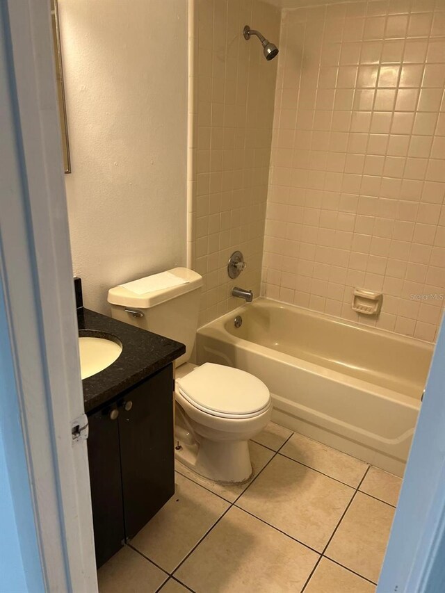 bathroom featuring vanity, tile patterned flooring, shower / bathtub combination, and toilet