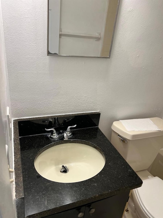 bathroom with toilet and vanity