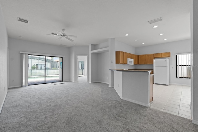 16614 Lazy Breeze Loop, Clermont, FL 34714 - unfurnished living room featuring light carpet, a ceiling fan, baseboards, recessed lighting, and light tile patterned flooring