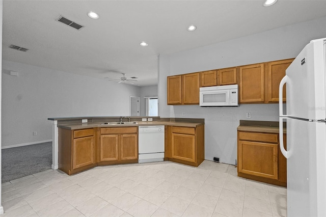 16614 Lazy Breeze Loop, Clermont, FL 34714 - kitchen featuring white appliances, brown cabinets, ceiling fan, a peninsula, and recessed lighting
