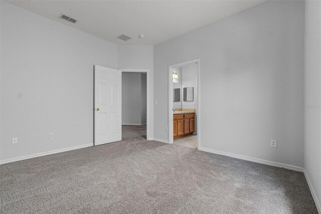 16614 Lazy Breeze Loop, Clermont, FL 34714 - unfurnished bedroom with carpet, baseboards, and ensuite bathroom