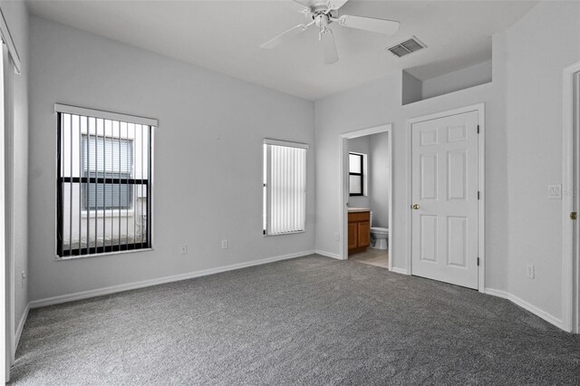 16614 Lazy Breeze Loop, Clermont, FL 34714 - unfurnished bedroom with carpet floors, connected bathroom, baseboards, and a ceiling fan