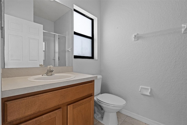 16614 Lazy Breeze Loop, Clermont, FL 34714 - bathroom featuring a stall shower, vanity, toilet, tile patterned flooring, and baseboards