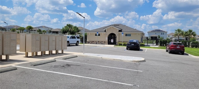 1556 Aspen Ave, Davenport, FL 33837 - uncovered parking lot featuring mail area and a residential view