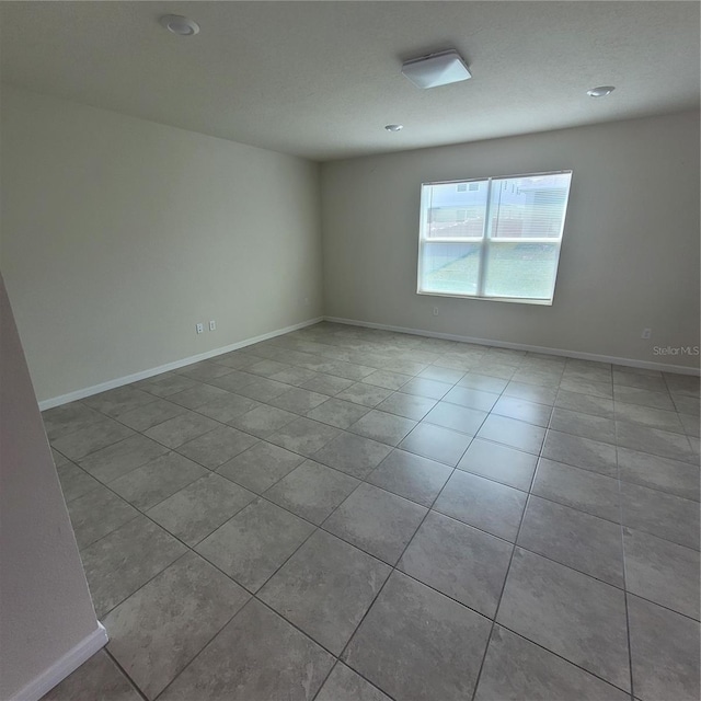 1556 Aspen Ave, Davenport, FL 33837 - tiled spare room featuring baseboards and recessed lighting