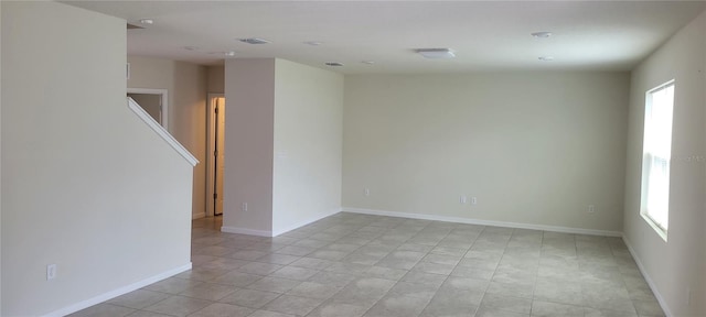 1556 Aspen Ave, Davenport, FL 33837 - empty room with light tile patterned floors and baseboards