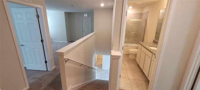 1556 Aspen Ave, Davenport, FL 33837 - bathroom featuring toilet, vanity, tiled shower, tile patterned floors, and baseboards