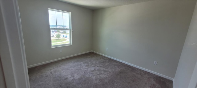 1556 Aspen Ave, Davenport, FL 33837 - carpeted empty room featuring healthy amount of natural light and baseboards
