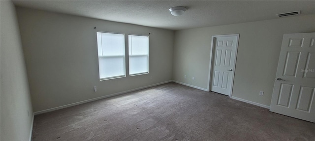 1556 Aspen Ave, Davenport, FL 33837 - unfurnished bedroom featuring carpet, baseboards, and a textured ceiling