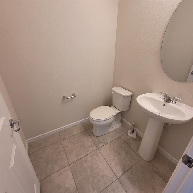 1556 Aspen Ave, Davenport, FL 33837 - half bathroom with toilet, tile patterned flooring, and baseboards