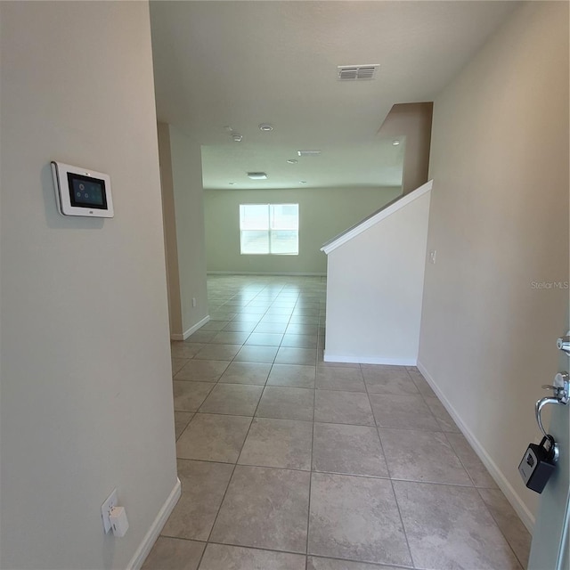1556 Aspen Ave, Davenport, FL 33837 - hallway featuring light tile patterned floors and baseboards