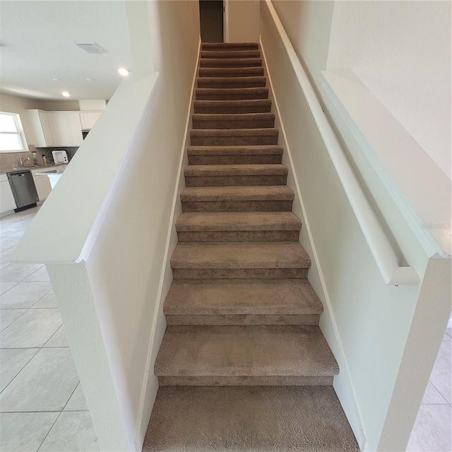 1556 Aspen Ave, Davenport, FL 33837 - staircase with tile patterned floors and recessed lighting