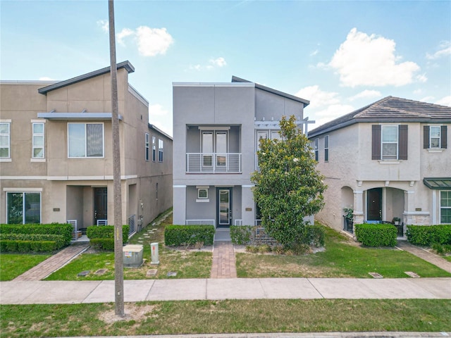 11037 Bagley Aly, Windermere, FL 34786 - view of property featuring a balcony, stucco siding, and a front yard