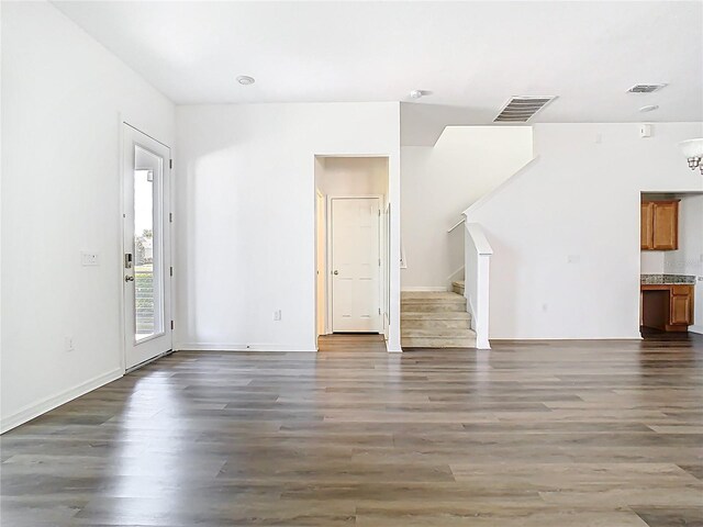11037 Bagley Aly, Windermere, FL 34786 - unfurnished living room featuring stairway, wood finished floors, and baseboards