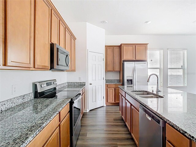 11037 Bagley Aly, Windermere, FL 34786 - kitchen with stainless steel appliances, a sink, dark wood-style floors, stone countertops, and recessed lighting