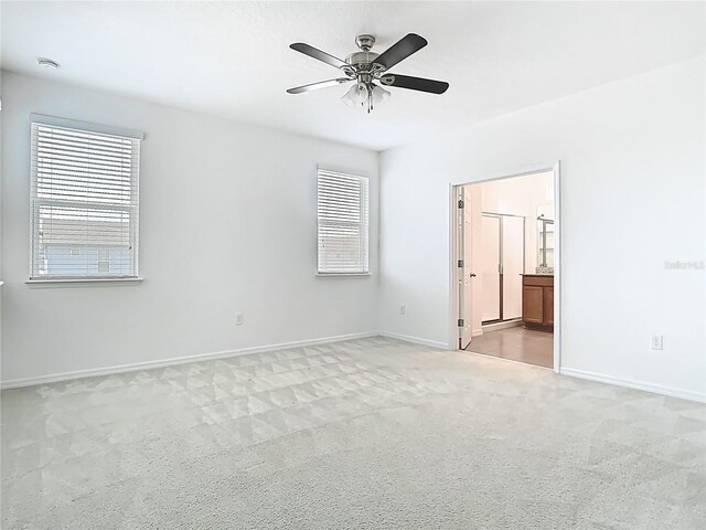 11037 Bagley Aly, Windermere, FL 34786 - empty room featuring healthy amount of natural light, ceiling fan, light colored carpet, and baseboards