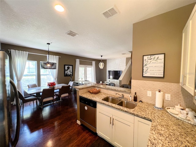 5356 Diplomat Ct Unit 108, Kissimmee, FL 34746 - kitchen featuring appliances with stainless steel finishes, a sink, light stone countertops, white cabinets, and dark wood-style flooring