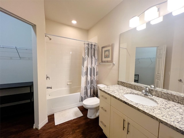 5356 Diplomat Ct Unit 108, Kissimmee, FL 34746 - bathroom with wood finished floors, shower / tub combo with curtain, a walk in closet, vanity, and toilet