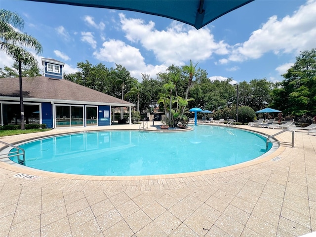 5356 Diplomat Ct Unit 108, Kissimmee, FL 34746 - community pool featuring a patio and view of scattered trees