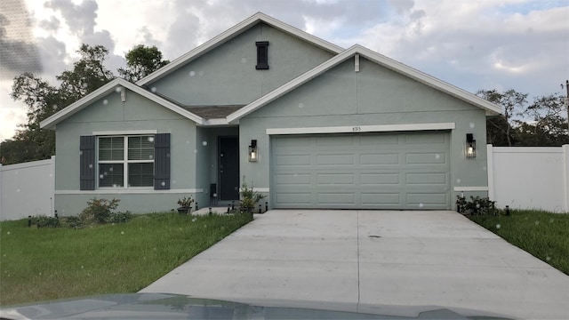 6315 Hillview Rd, Spring Hill, FL 34606 - traditional home with stucco siding, an attached garage, and driveway