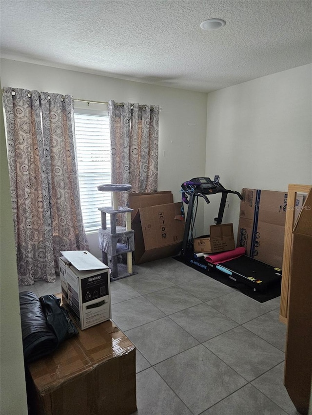 6315 Hillview Rd, Spring Hill, FL 34606 - exercise room with a textured ceiling and tile patterned floors