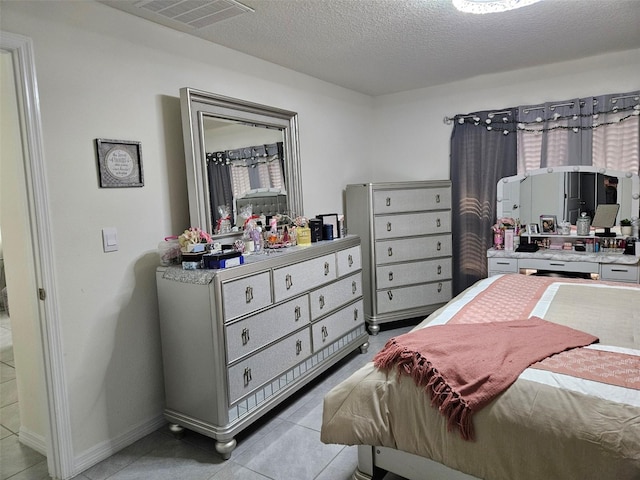 6315 Hillview Rd, Spring Hill, FL 34606 - bedroom with light tile patterned floors, a textured ceiling, and baseboards