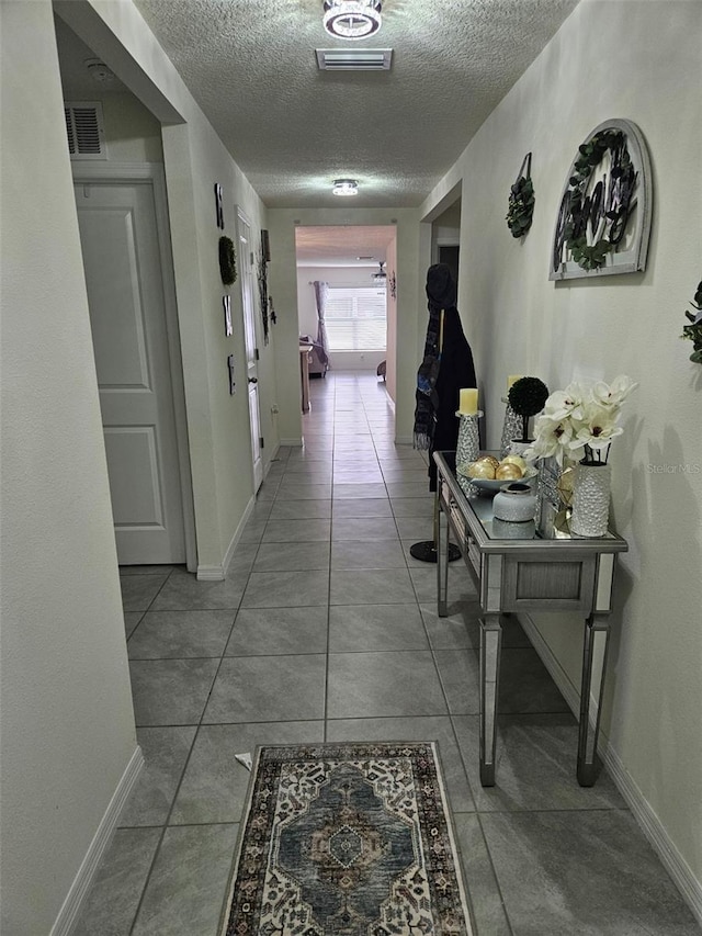 6315 Hillview Rd, Spring Hill, FL 34606 - corridor with a textured ceiling, baseboards, and tile patterned floors
