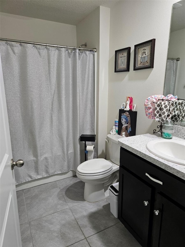 6315 Hillview Rd, Spring Hill, FL 34606 - full bathroom with vanity, toilet, tile patterned floors, a textured ceiling, and a shower with curtain
