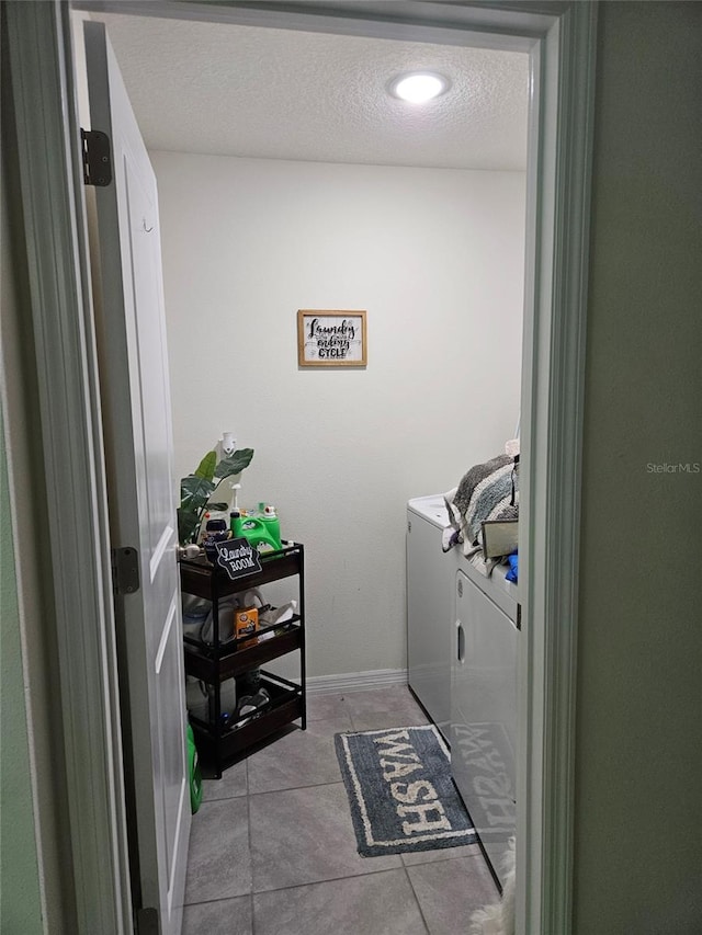 6315 Hillview Rd, Spring Hill, FL 34606 - washroom featuring washer and dryer, baseboards, tile patterned flooring, and a textured ceiling