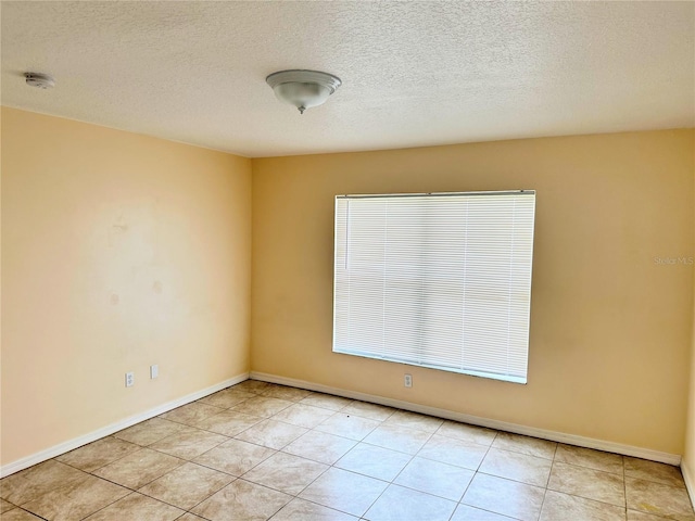 19 Rainbow Ln, Palm Coast, FL 32164 - spare room with a textured ceiling, a smoke detector, light tile patterned floors, and baseboards