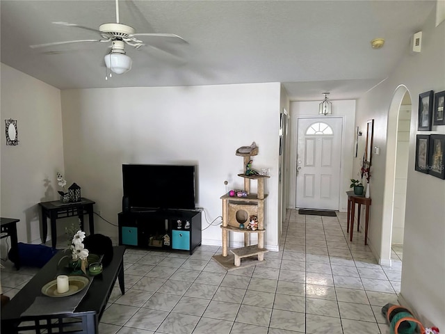19 Rainbow Ln, Palm Coast, FL 32164 - living room with arched walkways, light marble finish flooring, and ceiling fan