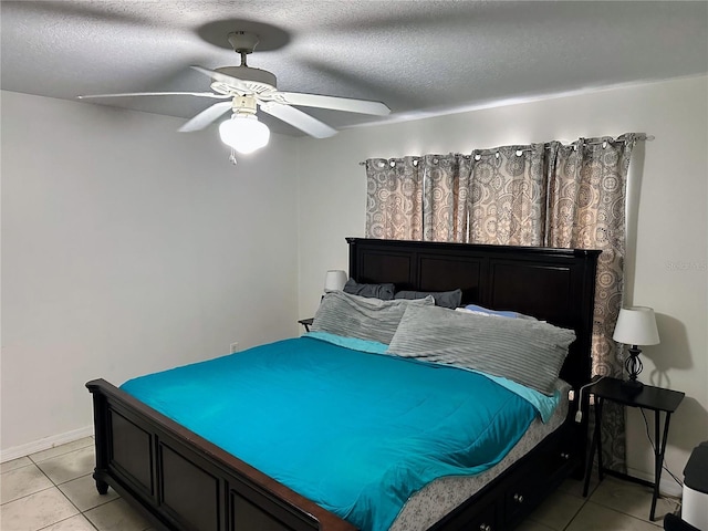 19 Rainbow Ln, Palm Coast, FL 32164 - bedroom with light tile patterned floors, ceiling fan, a textured ceiling, and baseboards