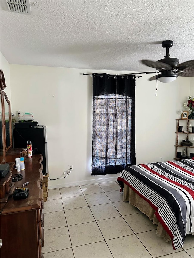 19 Rainbow Ln, Palm Coast, FL 32164 - bedroom with light tile patterned floors, a textured ceiling, and baseboards