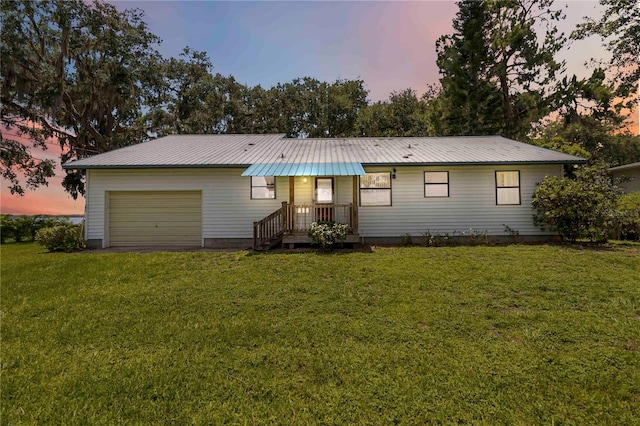 2740 Barker Rd, Saint Cloud, FL 34771 - single story home with a garage, a metal roof, and a lawn