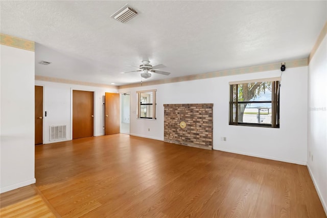 2740 Barker Rd, Saint Cloud, FL 34771 - spare room featuring ceiling fan, healthy amount of natural light, wood finished floors, and a textured ceiling