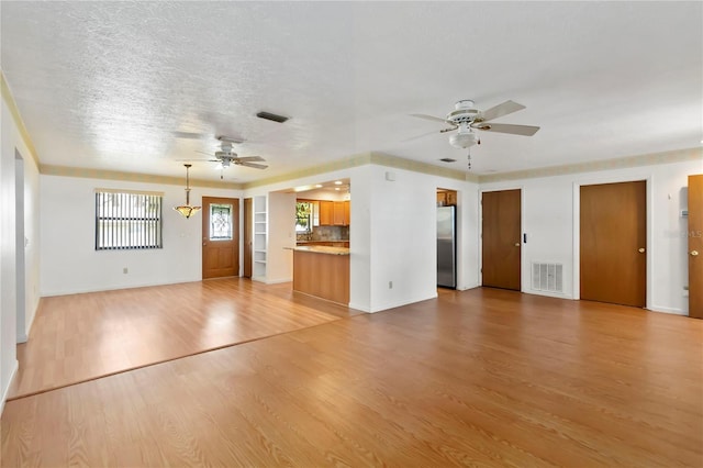 2740 Barker Rd, Saint Cloud, FL 34771 - unfurnished living room with ceiling fan and light wood-style flooring